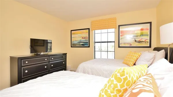 a bedroom with a bed and a flat screen tv