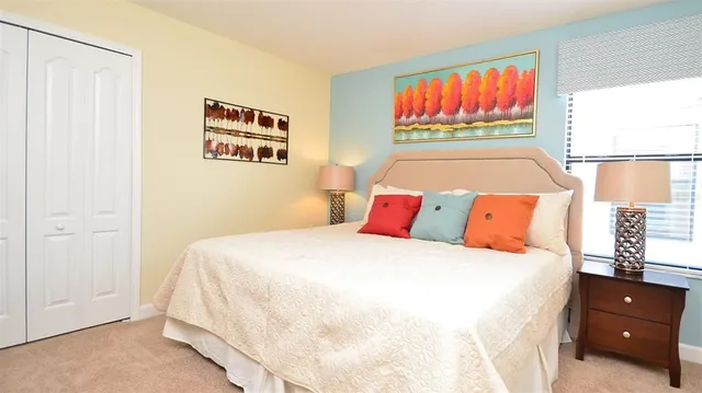 a bedroom with two beds and painting on the wall