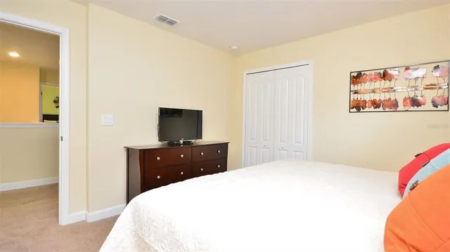a bedroom with two beds and a flat screen tv
