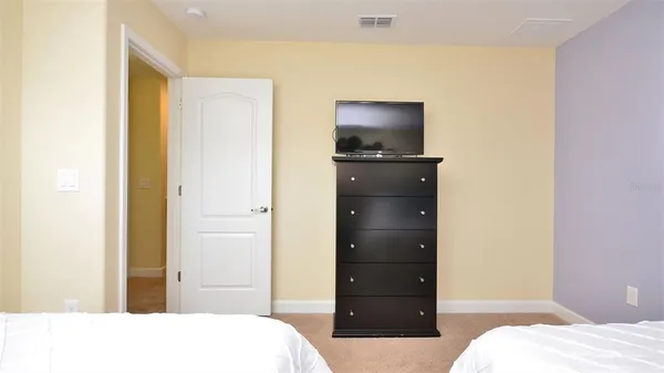a bedroom with a bed and flat screen tv