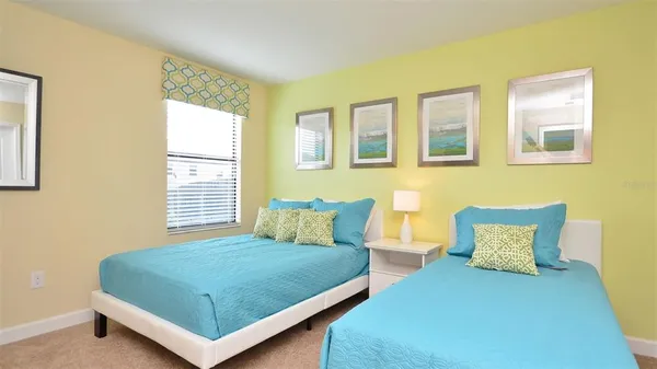 a large bed sitting in a bedroom next to a lamp