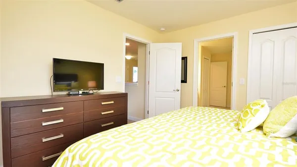a bathroom with a granite countertop sink a toilet and shower