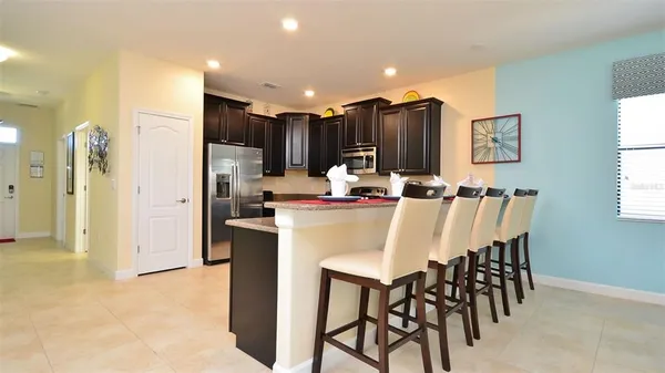 a kitchen with kitchen island appliances cabinets and furniture