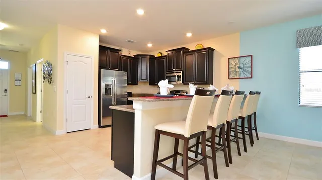 a kitchen with kitchen island appliances cabinets and furniture