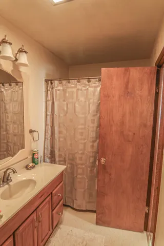 a bathroom with a granite countertop sink and a mirror