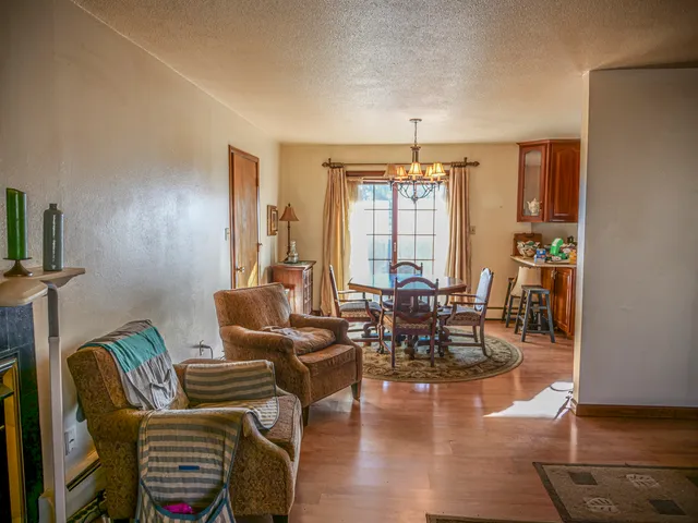 a living room with furniture and a chandelier