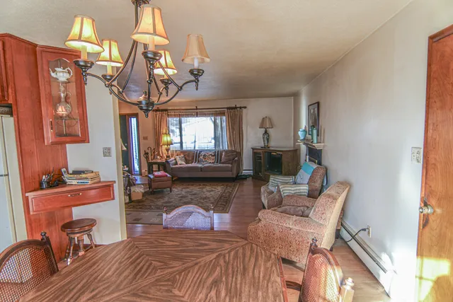 a living room with furniture a rug and a chandelier