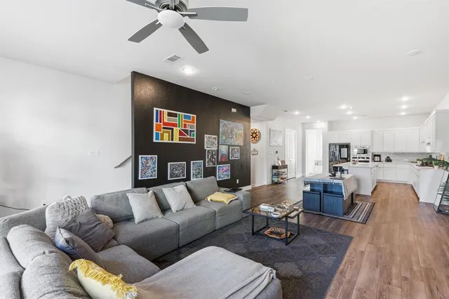 a living room with furniture and kitchen view