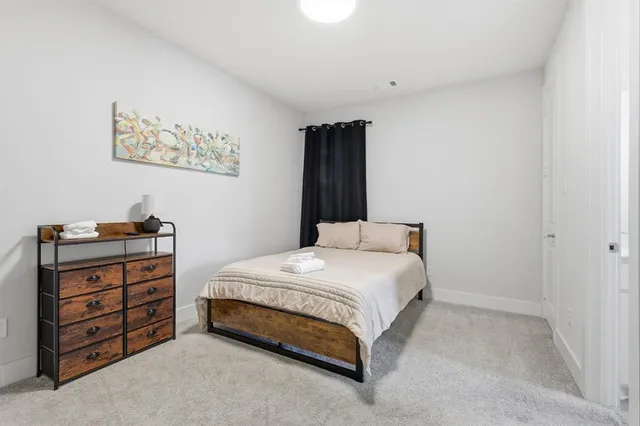 a bedroom with a bed and a dresser