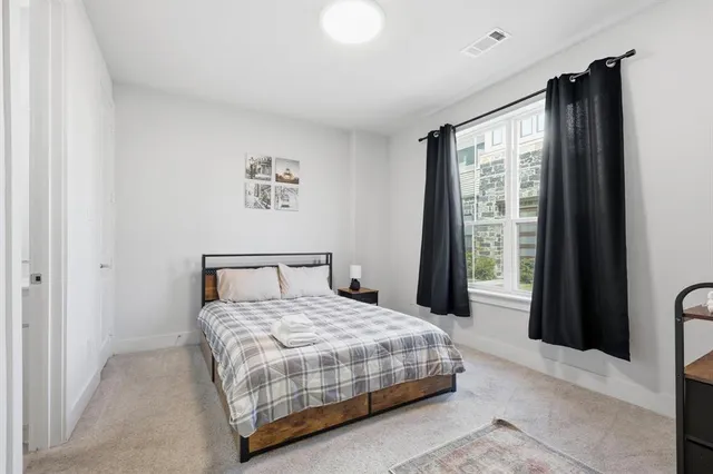 a bedroom with a large bed and a large window