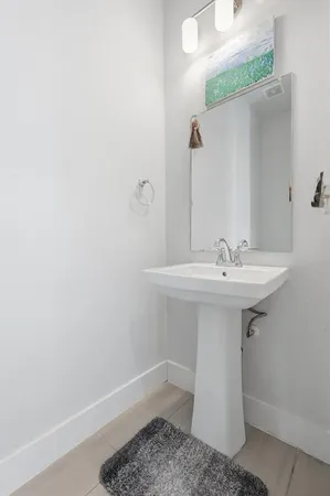 a bathroom with a sink a mirror and toilet