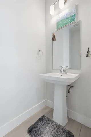 a bathroom with a sink a mirror and toilet