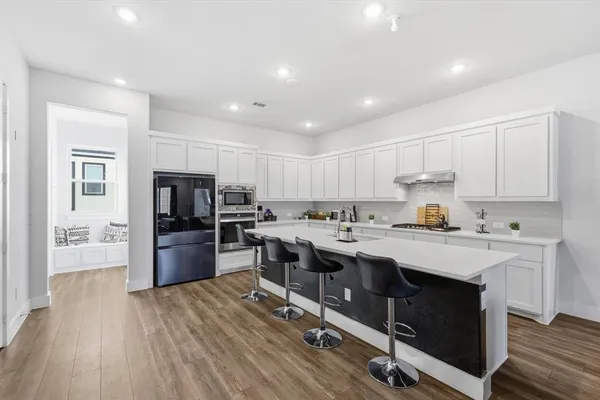 a kitchen with a sink a counter top stainless steel appliances and cabinets