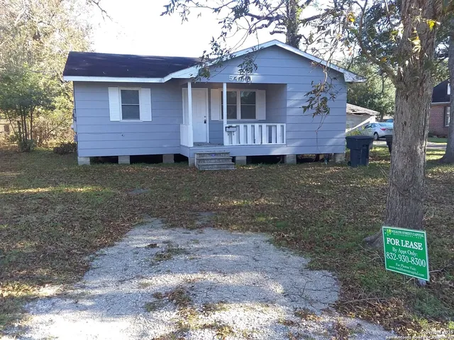 a view of a brick house with a yard