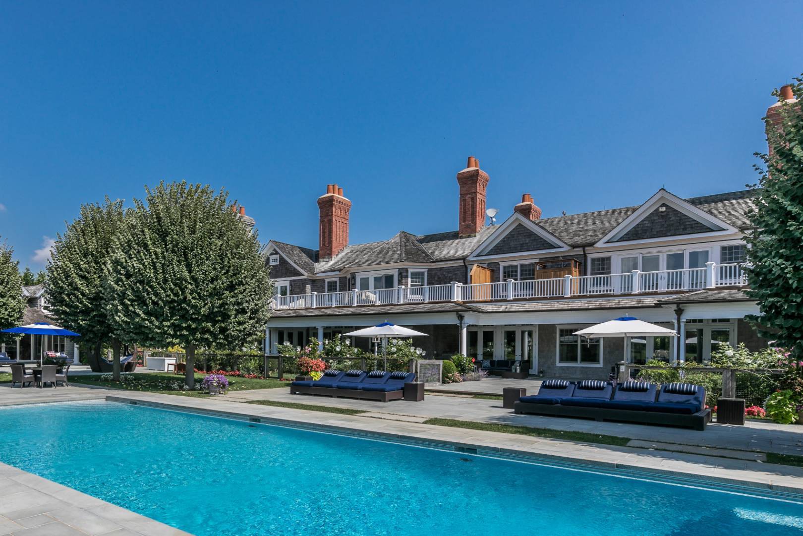 612 Halsey Lane Bridgehampton, NY 11932 - Photo 17 of 31 a front view of houses with yard and outdoor seating