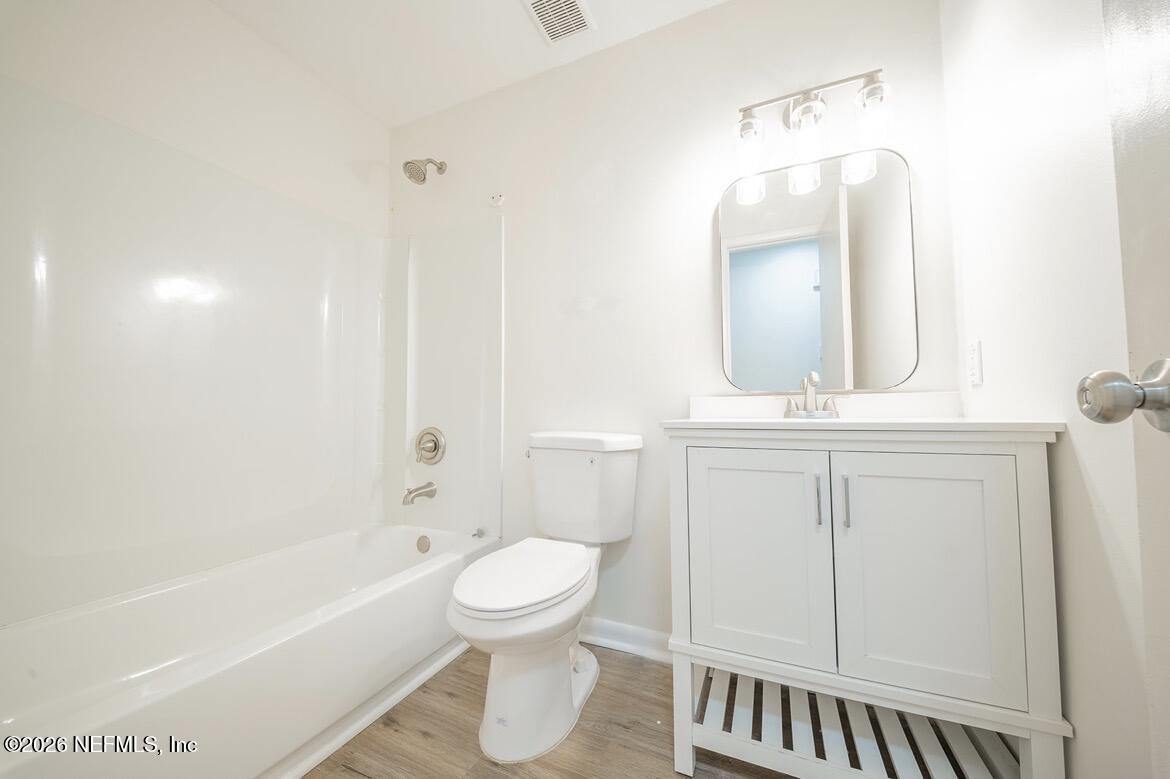 7762 Knoll Drive South Jacksonville, FL 32221 - Photo 11 of 22 a bathroom with a toilet a sink a mirror and bathtub