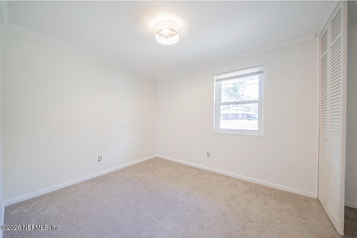 7762 Knoll Drive South Jacksonville, FL 32221 - Photo 12 of 22 an empty room with a window