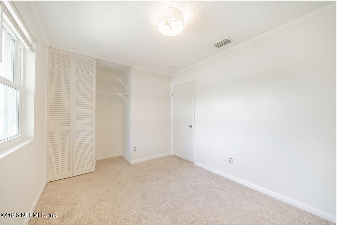 7762 Knoll Drive South Jacksonville, FL 32221 - Photo 13 of 22 an empty room with windows