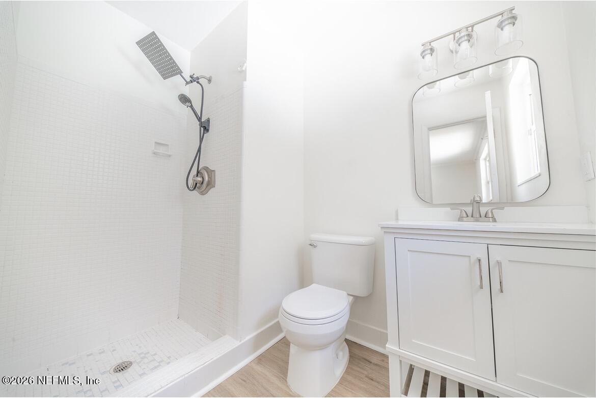 7762 Knoll Drive South Jacksonville, FL 32221 - Photo 14 of 22 a bathroom with a toilet a sink and mirror