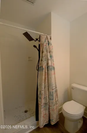 a bathroom with a toilet and shower