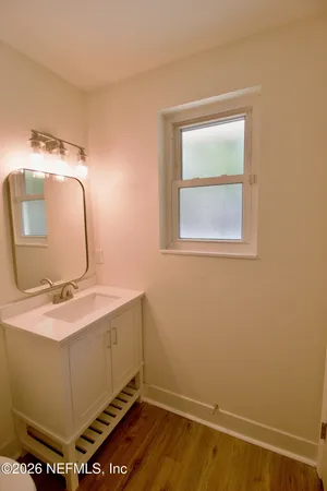 a room with a sink and a mirror