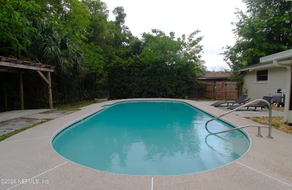 a view of a swimming pool with a patio