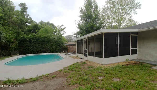 a view of a backyard with a large tree