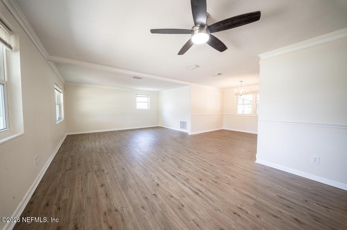 7762 Knoll Drive South Jacksonville, FL 32221 - Photo 4 of 22 wooden floor in an empty room with a window