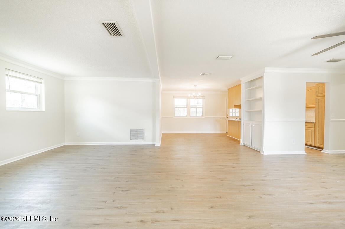 7762 Knoll Drive South Jacksonville, FL 32221 - Photo 5 of 22 a view of an empty room with window and wooden floor