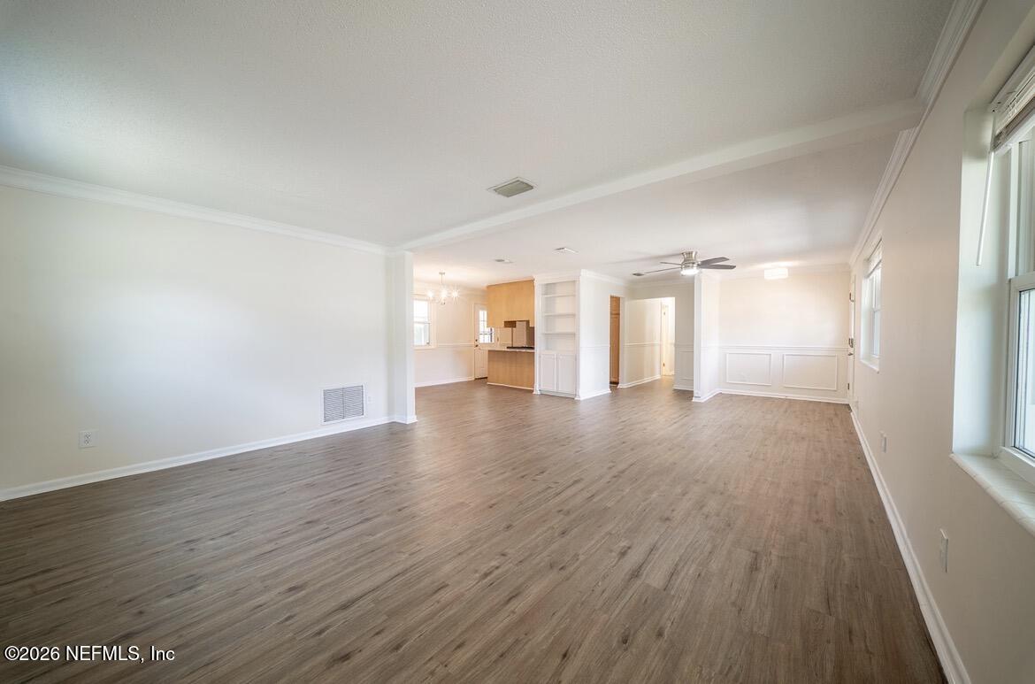 7762 Knoll Drive South Jacksonville, FL 32221 - Photo 6 of 22 wooden floor in an empty room with a window