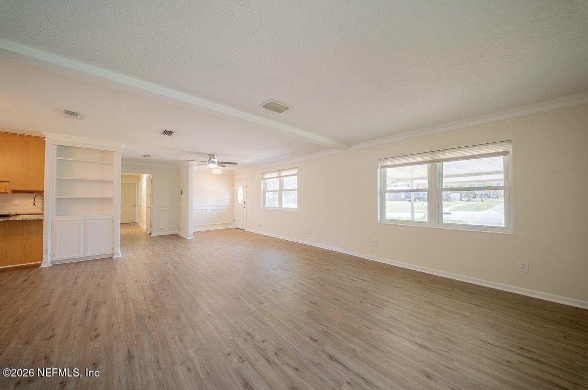 7762 Knoll Drive South Jacksonville, FL 32221 - Photo 7 of 22 an empty room with wooden floor and windows