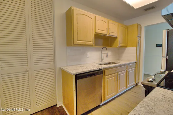a kitchen with stainless steel appliances granite countertop a sink and cabinets