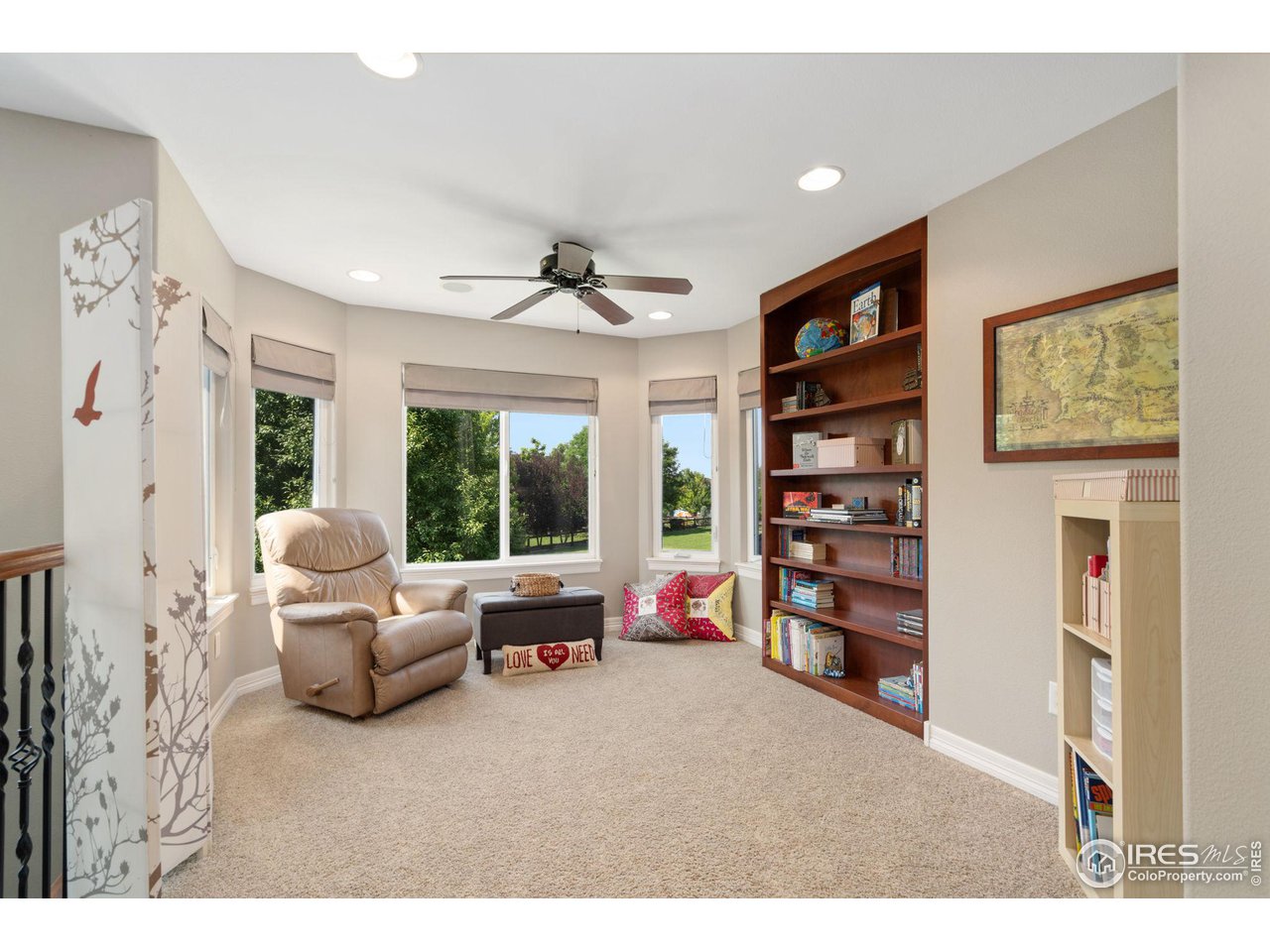 6523 Aberdour Circle Windsor, CO 80550 - Photo 17 of 40 a living room with furniture and a large window