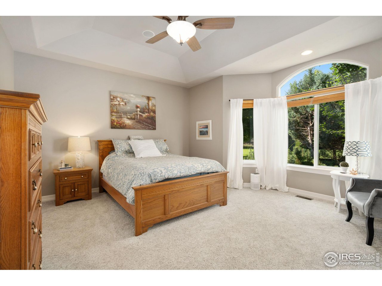 6523 Aberdour Circle Windsor, CO 80550 - Photo 19 of 40 a spacious bedroom with a bed and a large window