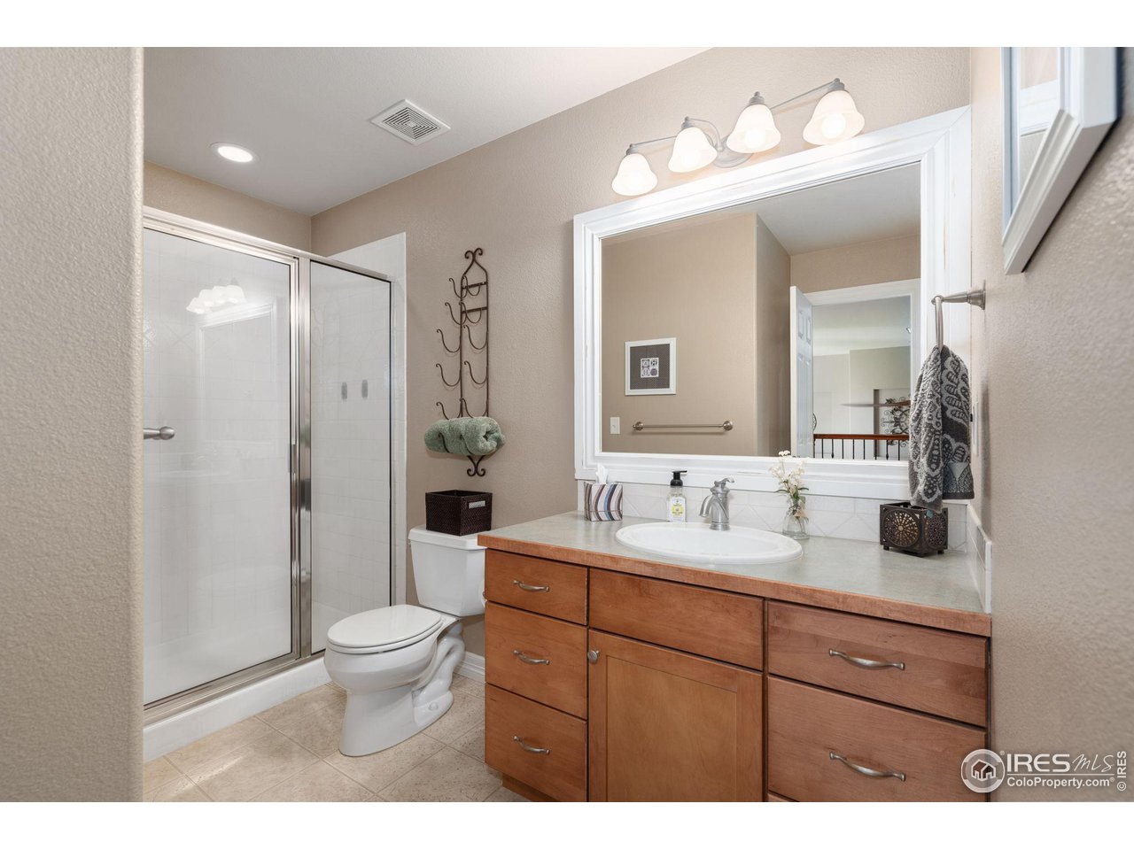 6523 Aberdour Circle Windsor, CO 80550 - Photo 23 of 40 a bathroom with a toilet sink double vanity and mirror