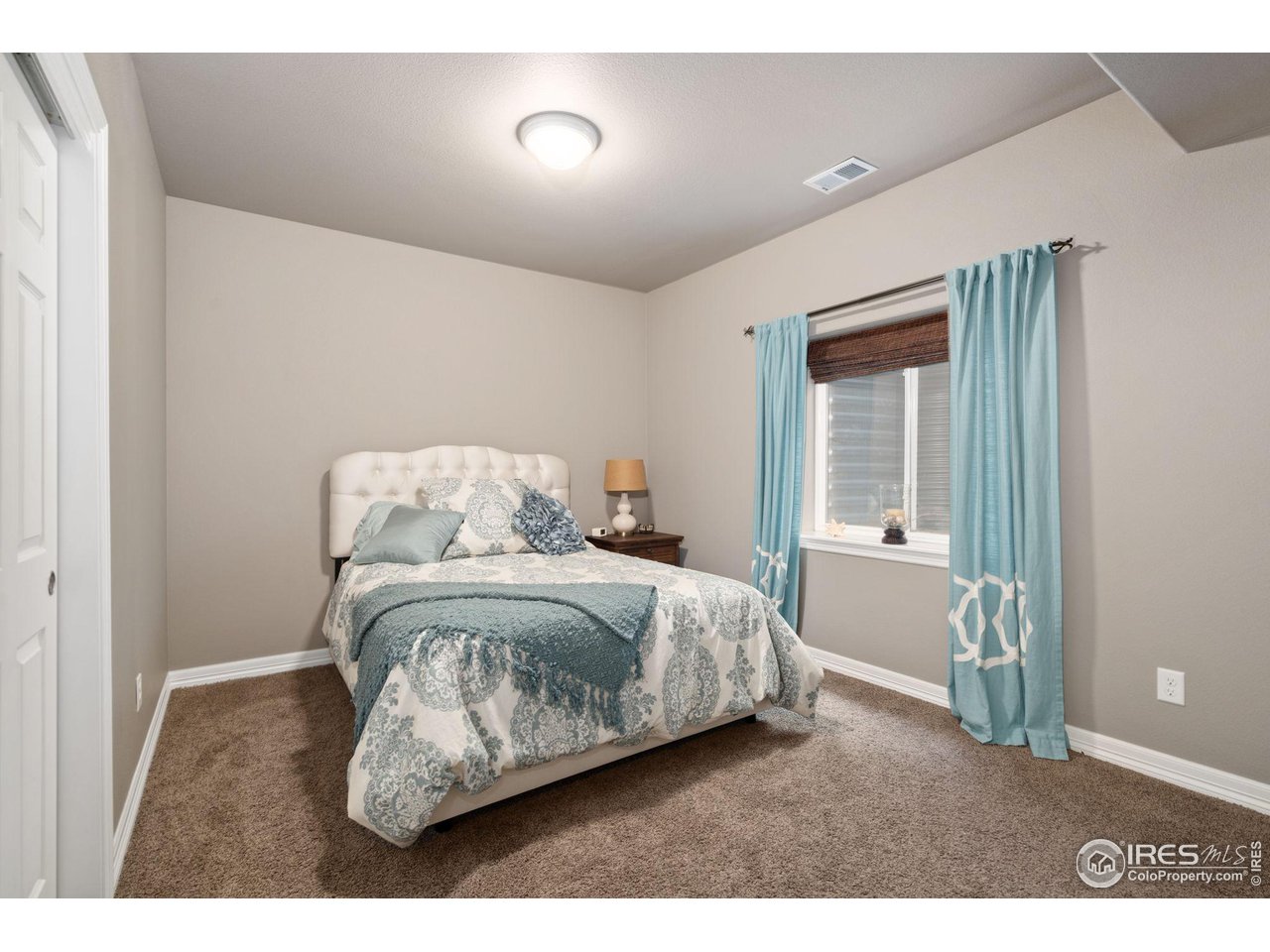 6523 Aberdour Circle Windsor, CO 80550 - Photo 30 of 40 a bedroom with a bed and a window