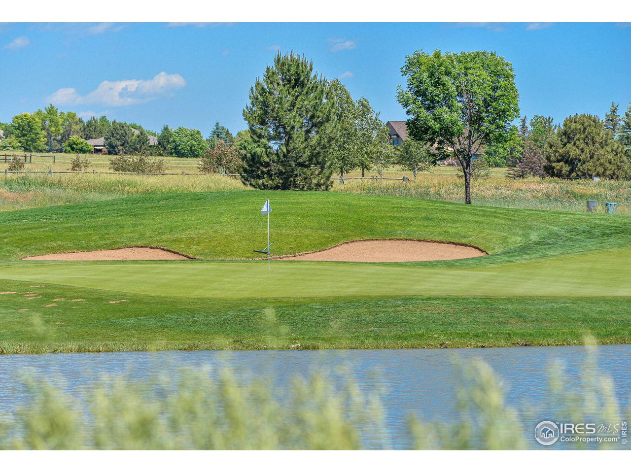 6523 Aberdour Circle Windsor, CO 80550 - Photo 38 of 40 a view of a golf course with a lake view