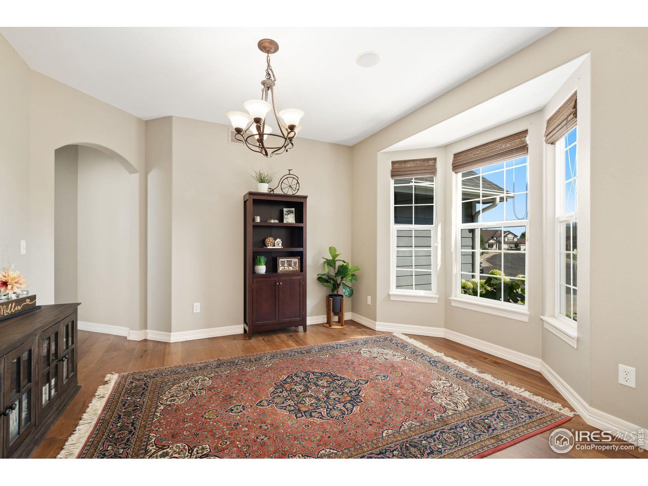6523 Aberdour Circle Windsor, CO 80550 - Photo 5 of 40 a view of a livingroom with a furniture wooden floor and a chandelier