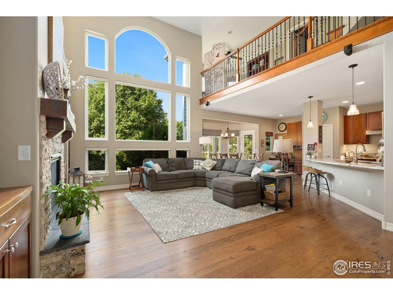 6523 Aberdour Circle Windsor, CO 80550 - Photo 8 of 40 a living room with furniture fireplace and a large window