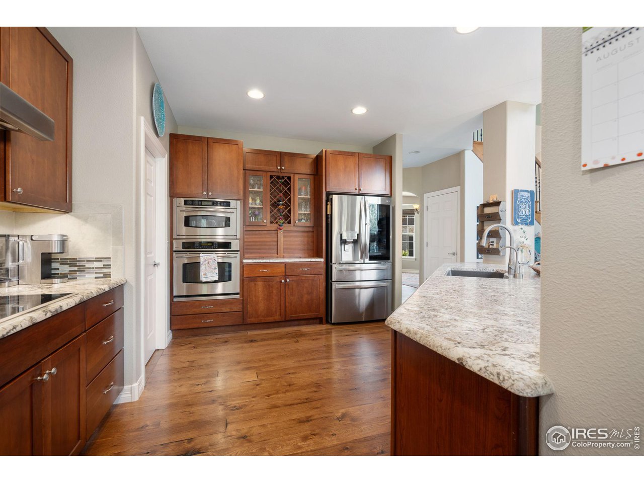 6523 Aberdour Circle Windsor, CO 80550 - Photo 10 of 40 a kitchen with stainless steel appliances granite countertop a refrigerator and a sink
