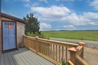 11 Sunset Drive Newbury, MA 01951 - Photo 2 of 16 a view of a balcony with wooden floor and fence