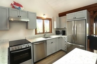 11 Sunset Drive Newbury, MA 01951 - Photo 10 of 16 a kitchen with a sink stove and refrigerator