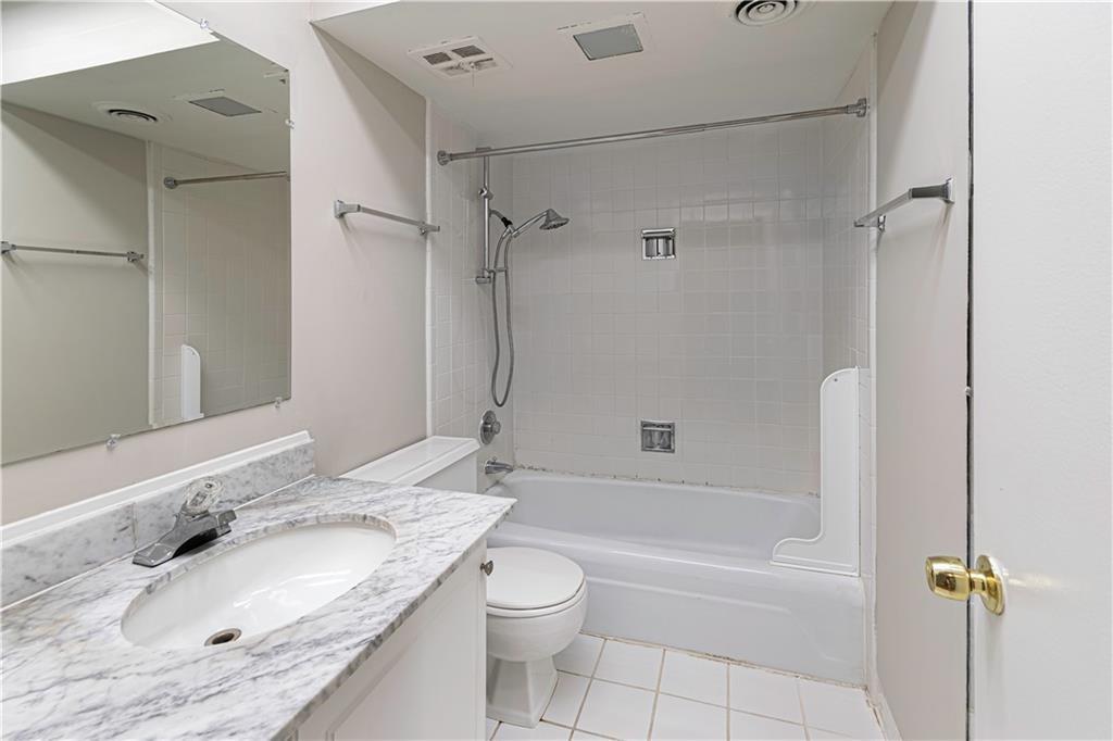 3071 Colonial Way, Unit E Atlanta, GA 30341 - Photo 14 of 16 a bathroom with a granite countertop sink toilet tub and shower