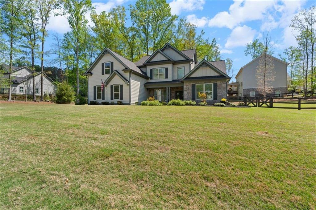 7610 Scenic Overlook Cumming, GA 30041 - Photo 7 of 62 a front view of a house with a garden and trees