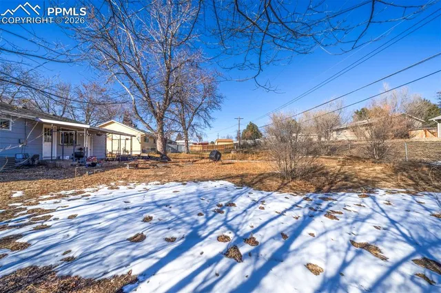 a view of yard with wooden fence