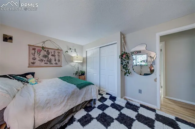 a bedroom with a bed and a mirror