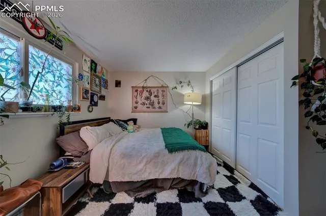 a bed sitting in a bedroom next to a window