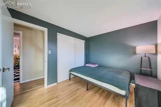 a bedroom with a bed and a mirror