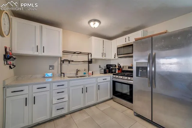a kitchen with cabinets stainless steel appliances and a counter space