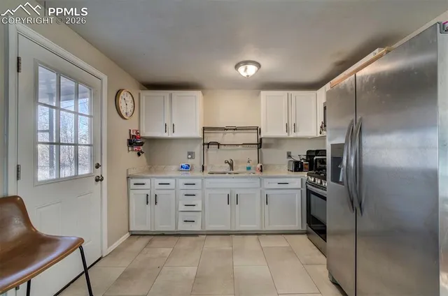 a kitchen with stainless steel appliances granite countertop a refrigerator sink and cabinets